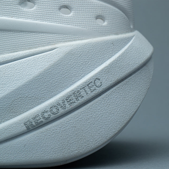 Text on outsole labeled "recovertec" on white Somexc recovery sneaker#color_white